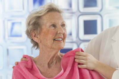 caregiver assisting elder woman for shower